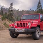 Red Jeep Parked in the Middle of a Dirt Road